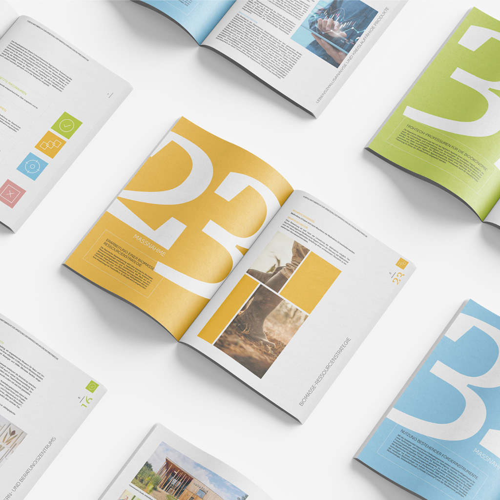 Das Bild zeigt mehrere aufgeschlagene Fortschrittsberichte, die jeweils großformatige Zahlen und farbige Seitenlayouts enthalten, die verschiedene Maßnahmen und Inhalte präsentieren.